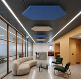 Hexagon felt ceiling rafts in blue and natural hanging along a reception corridor with a curved sofa