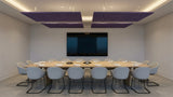 Two purple square felt ceiling rafts hanging above a long boardroom table facing a wall screen