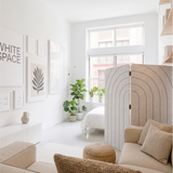 White arches engraved folding room divider dividing an open plan room