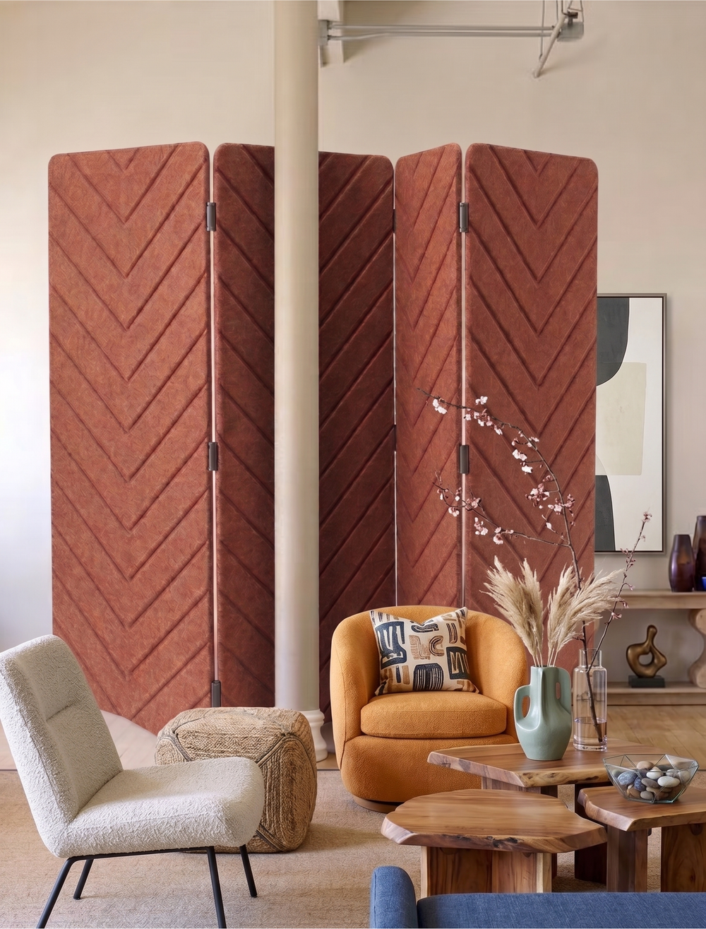 A set of four folding room dividers with a textured chevron pattern in terracotta rust, styled in a modern living room setting.