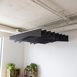Crimp felt ceiling baffles in Galaxy in a room with bookshelves and an exposed ceiling