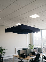 Crimp felt ceiling baffles in Midnight Blue over open-plan office desks
