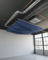 Drape felt ceiling baffles in Blue Jay below exposed ducting in a brick-walled room