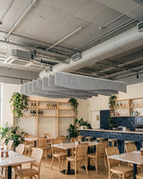 Drape felt ceiling baffles in Silver Grey hung over the dining tables of a restaurant