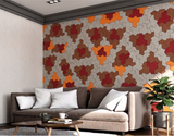 A living room feature wall of Einstein hat PET felt tiles in grey, brown, red and orange, above a sofa