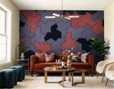 A living room feature wall of Einstein hat PET felt tiles in navy, blue-grey and rust, behind a velvet sofa