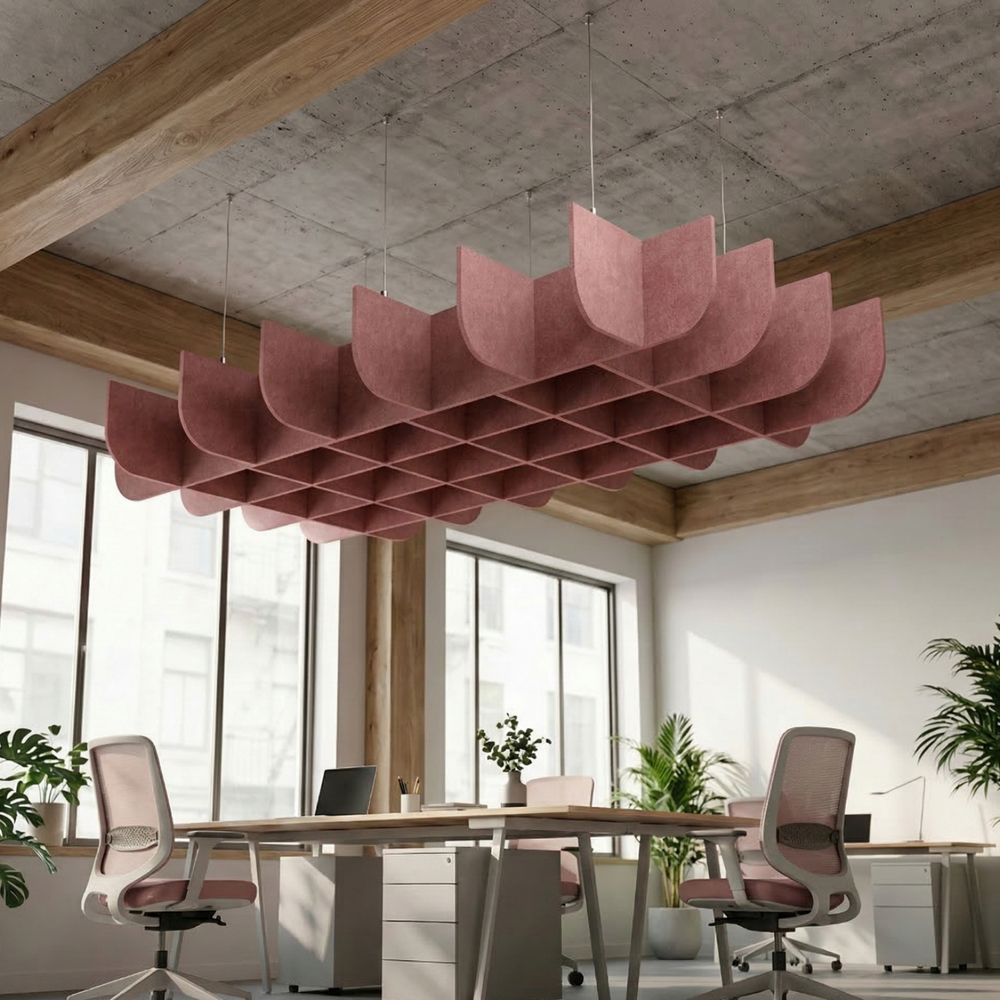 Modern office interior with pink ceiling light fixture, desks, and chairs.