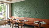 Orbit engraved felt wall panels in Sea Green, in a restaurant