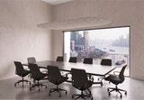 Pale grey oval felt ceiling raft hanging above a boardroom table with a city view