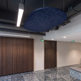 Navy oval felt ceiling raft suspended in an office lobby with timber slatted walls