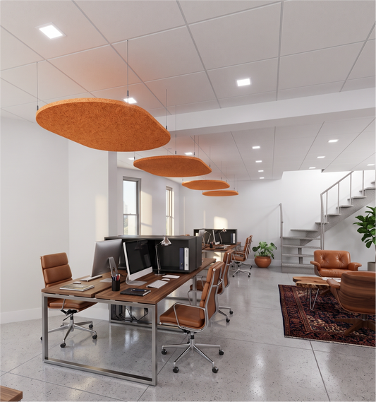 Row of orange oval felt ceiling rafts hanging above desks in an open-plan office
