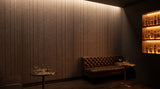 Pulse engraved felt wall panels in Doe, behind a bar