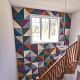 Colourful right angle triangle acoustic PET felt feature wall beside a staircase