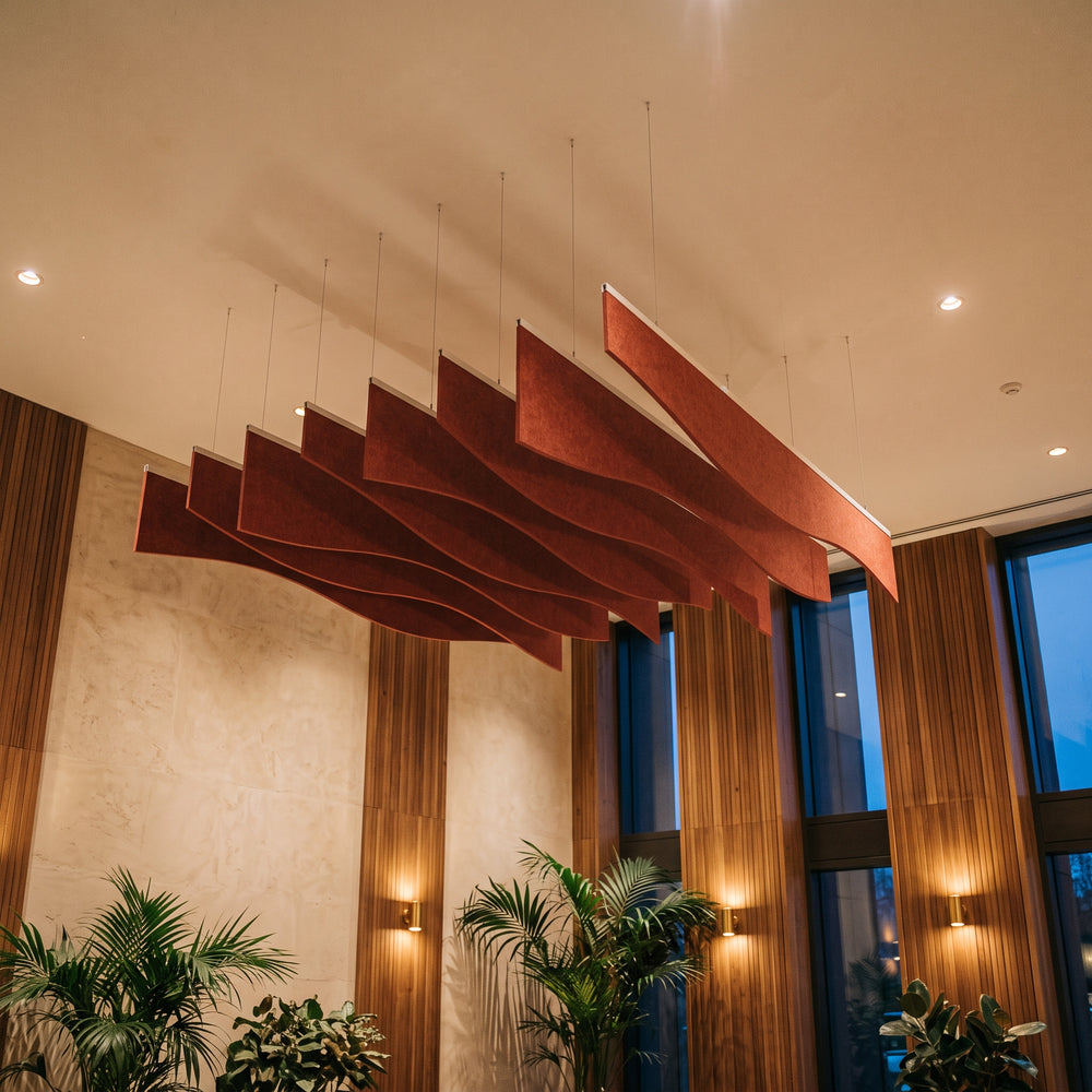 Ruche felt ceiling baffles in Dark Rouge over a lounge with timber wall panels
