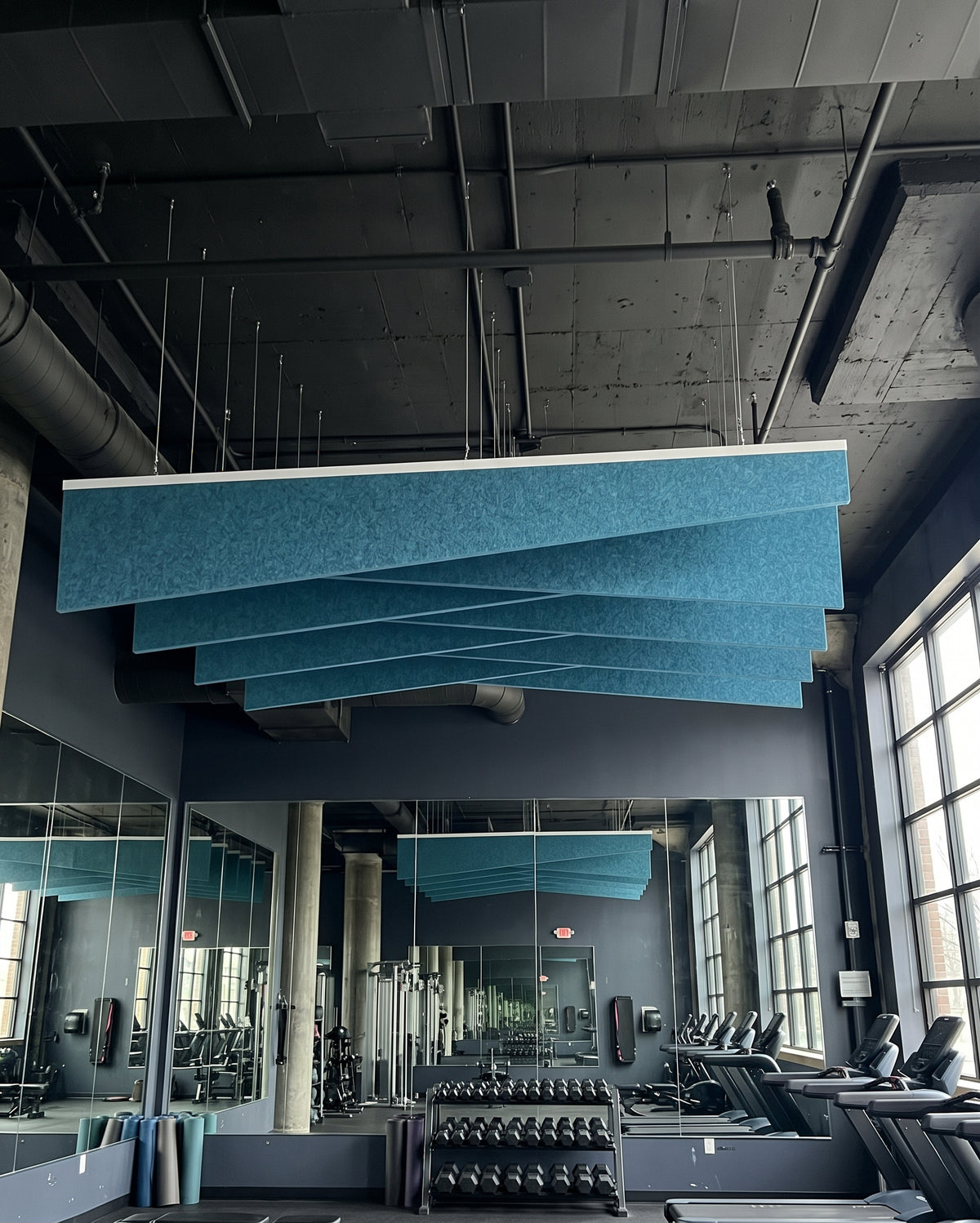Shear felt ceiling baffles in Dragonfly in a gym under an exposed ceiling