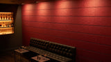 Shiplap engraved felt wall panels in Red, behind a bar