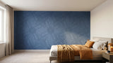 Terrain engraved felt wall panels in Steel Blue, behind a bed