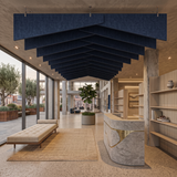 Deep ocean blue Felted trapezoid acoustic raft suspended over an open, light-filled space with full-height windows
