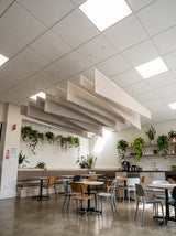 Twill felt ceiling baffles in Manilla Beige over a café seating area