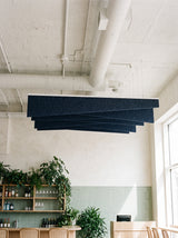 Twill felt ceiling baffles in Midnight Blue over a café counter
