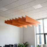 Twill felt ceiling baffles in Orange over an open-plan office